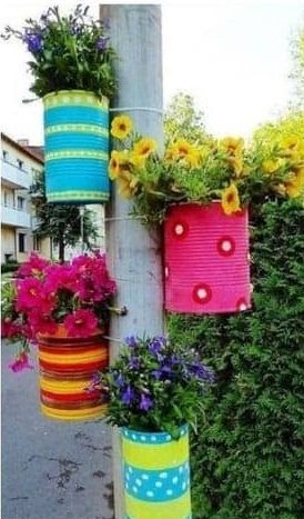 DIY old cans turned into colourful flower pots
