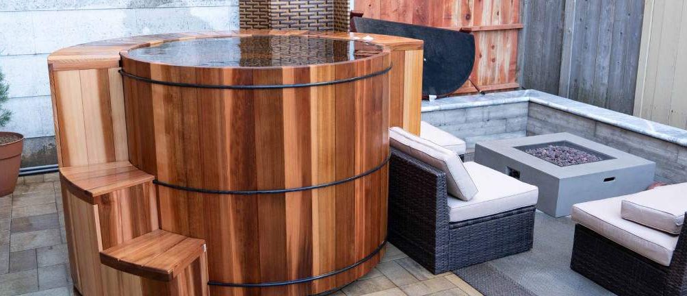 Oversized cedar hot tub with a stone fire pit