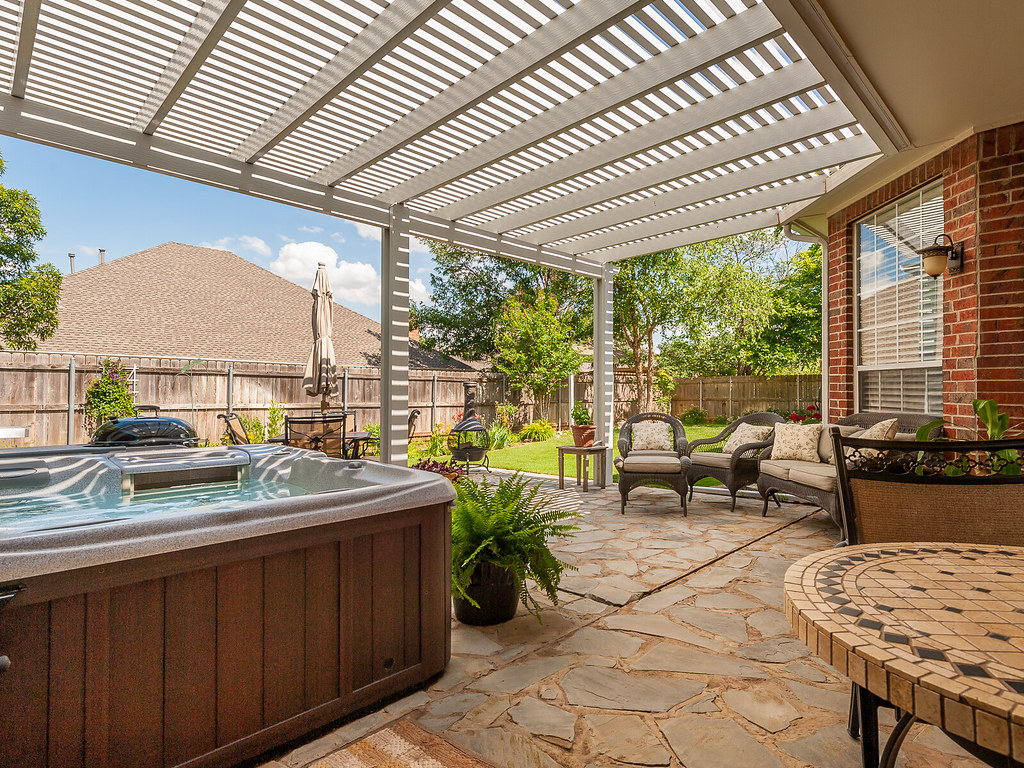 Corner privacy pergola area with an outdoor hot tub