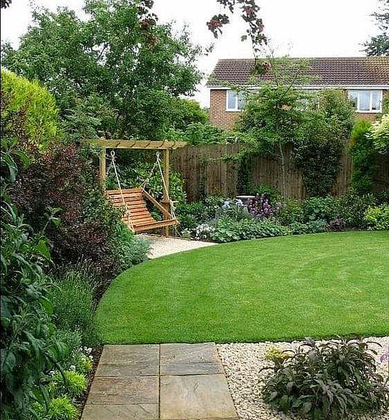 A garden with a small corner swing