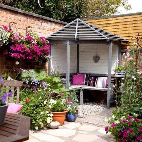 Corner arbour providing privacy and shelter in the garden