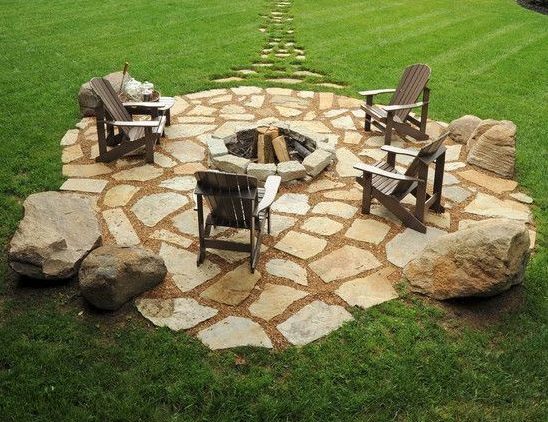 A natural stone patio in the middle dedicated to the fire pit