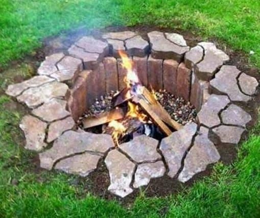 DIY buried fire pit lined with stones