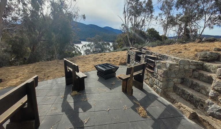 Private fire pit area in the mountains accompanied by two wooden chairs