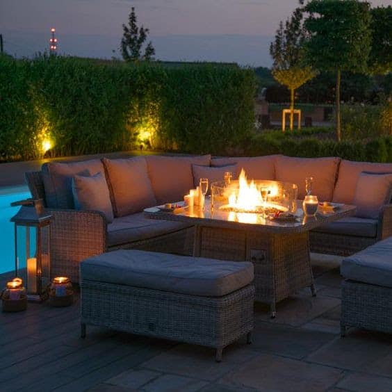 An outdoor dining table with fire pit in the middle
