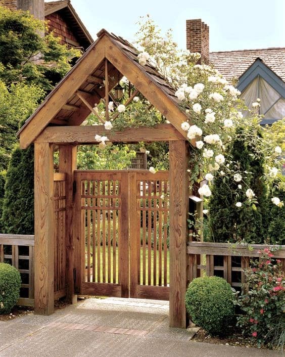A stylish gated arbour with surrounding greens and florals