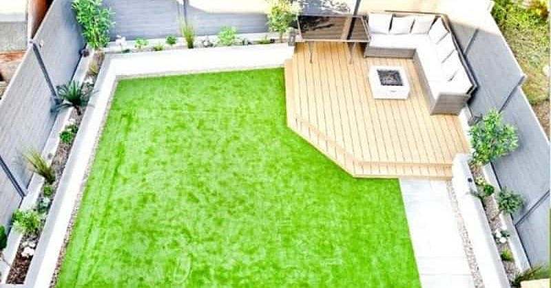 Aerial view of a corner deck with a comfortable seating area and lawn