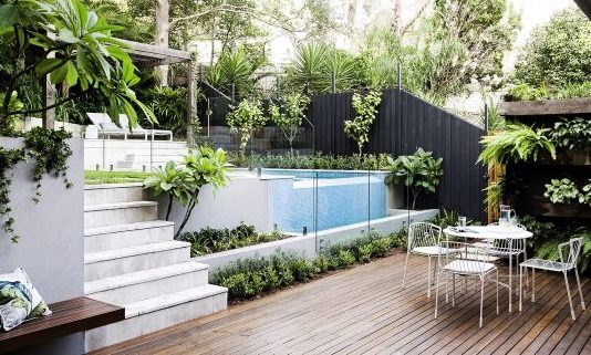 Sun patio, pool, and outdoor dining area in a multi-level garden