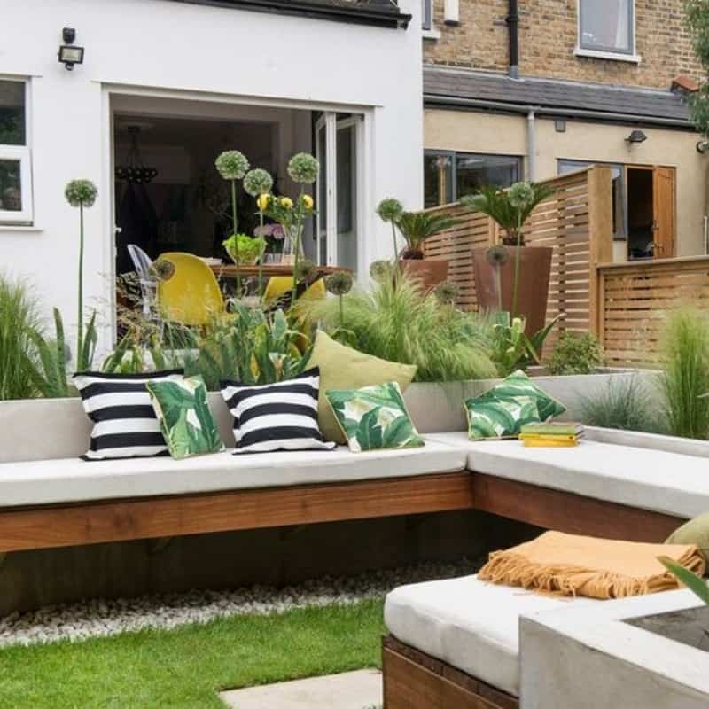 Multi-zoned garden with a dining table and a comfy couch