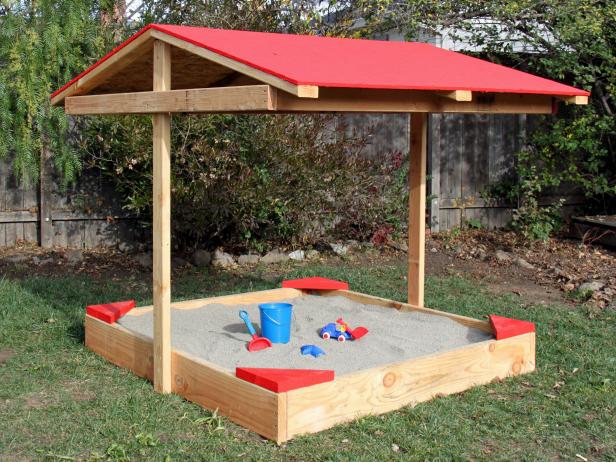 DIY covered sandbox made from pallets and with a red roof