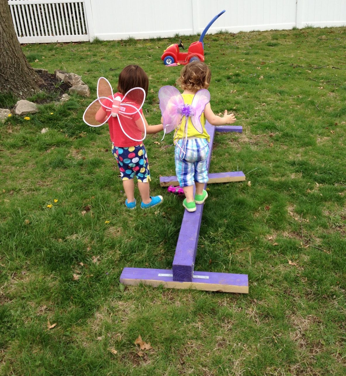 Kids trying out the DIY balance beam in purple colour