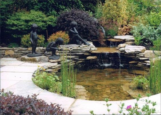 A garden pond decorated with statues