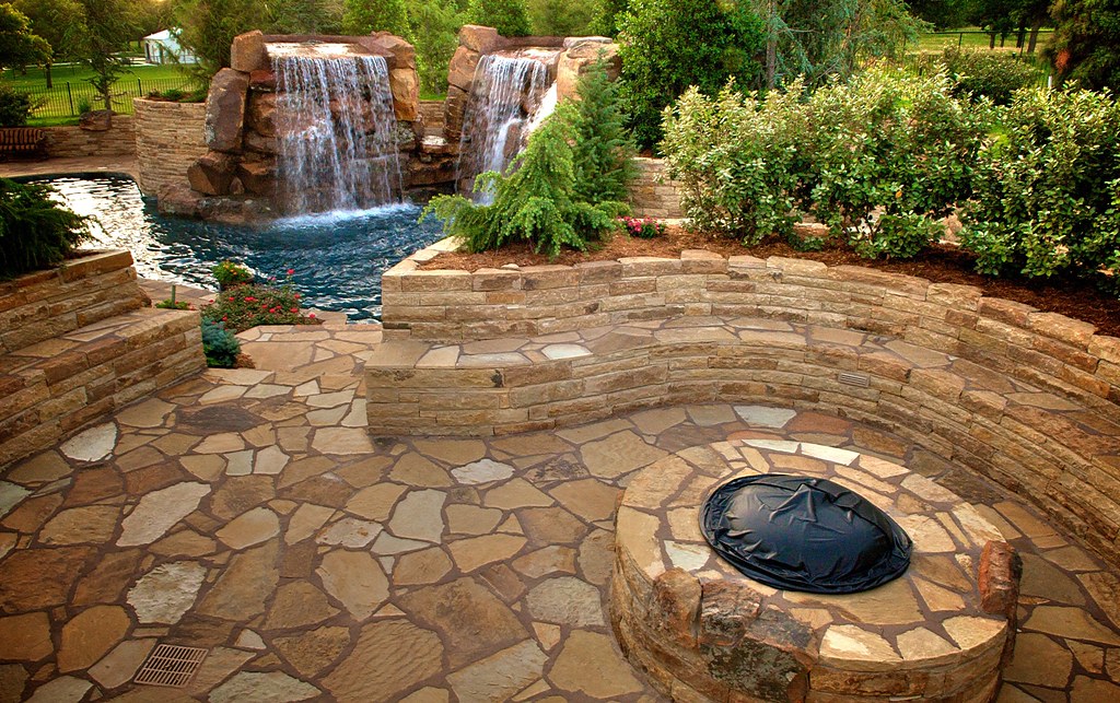 Stone waterfall and pond and fire pit area