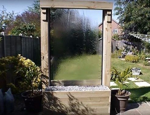 A simple clear wndow pane falling water feature