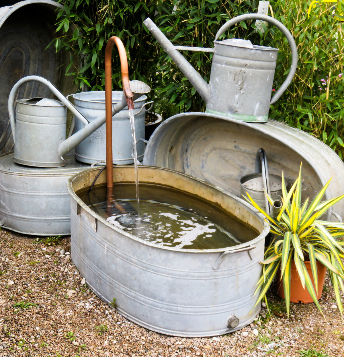 Pail, tin tub and old watering can fountain