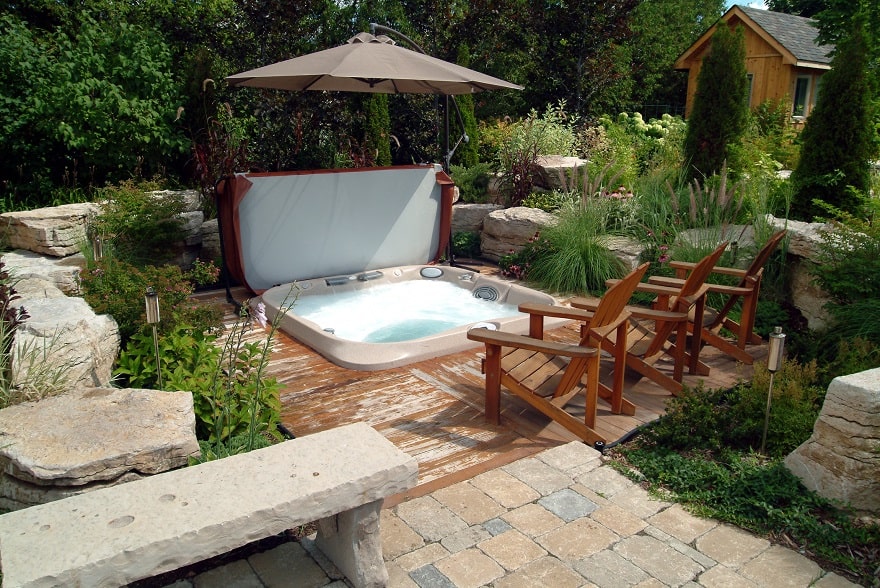 In-ground backyard hot tub with parasol for shade
