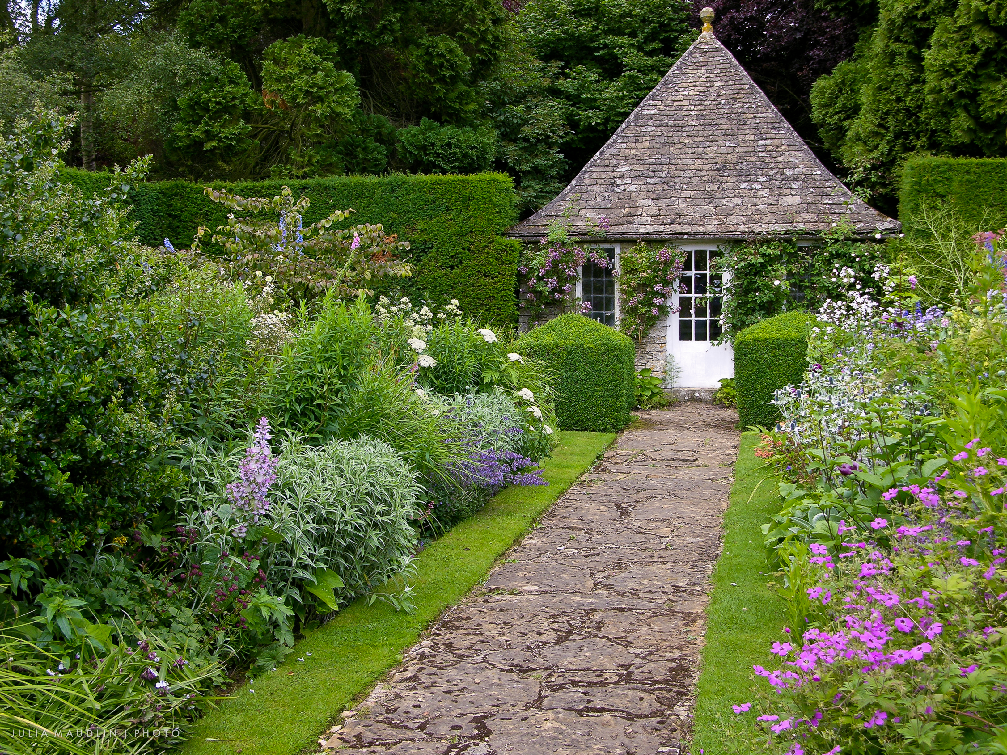 Stone pathway that leads to a stone summer house
