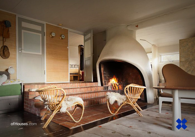Summer house interior with scoop-like fireplace