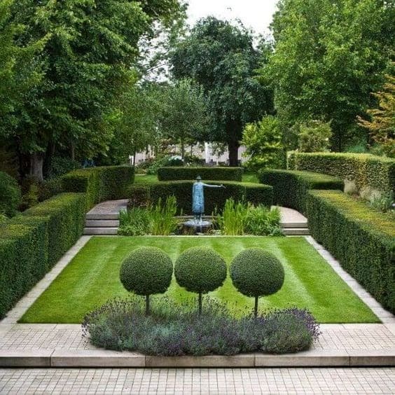 Perfectly pruned hedges and trees in a well-manicured garden