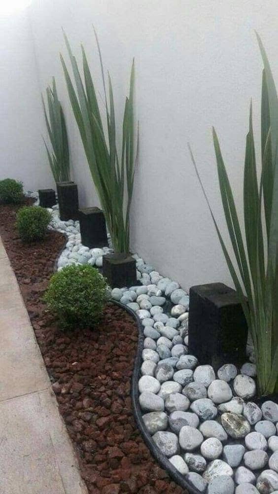Plant pots buried within a flower bed