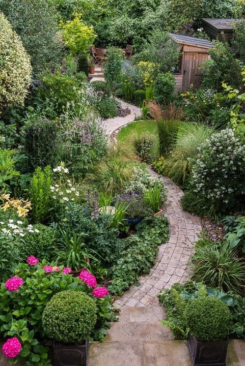 A brick winding path and more natural planting around
