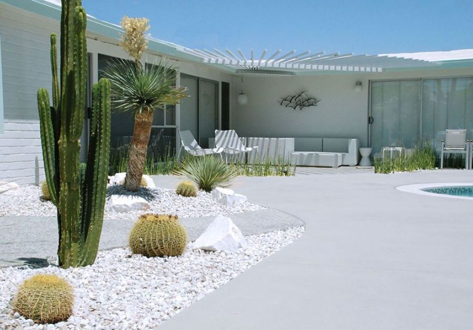 White stones and succulents in an all-white backyard