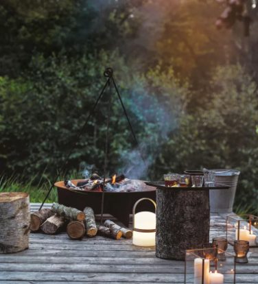 A night-friendly focal point in a sensory garden with a fire pit