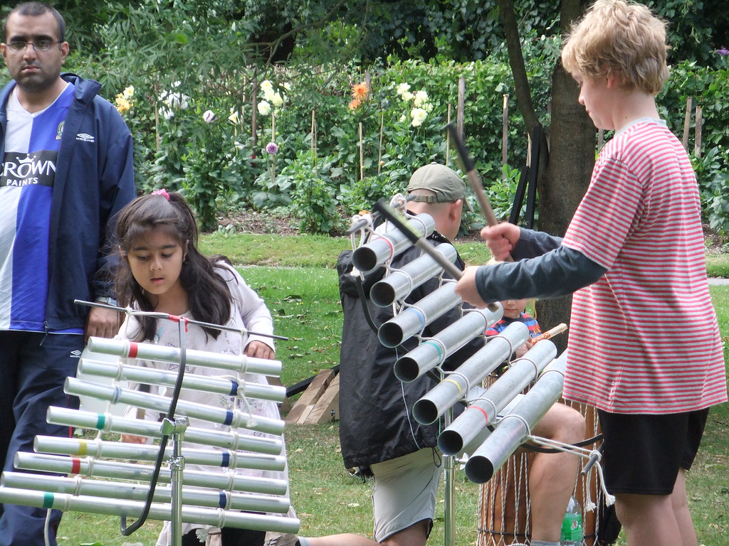 Kids playing DIY xylophone in the garden