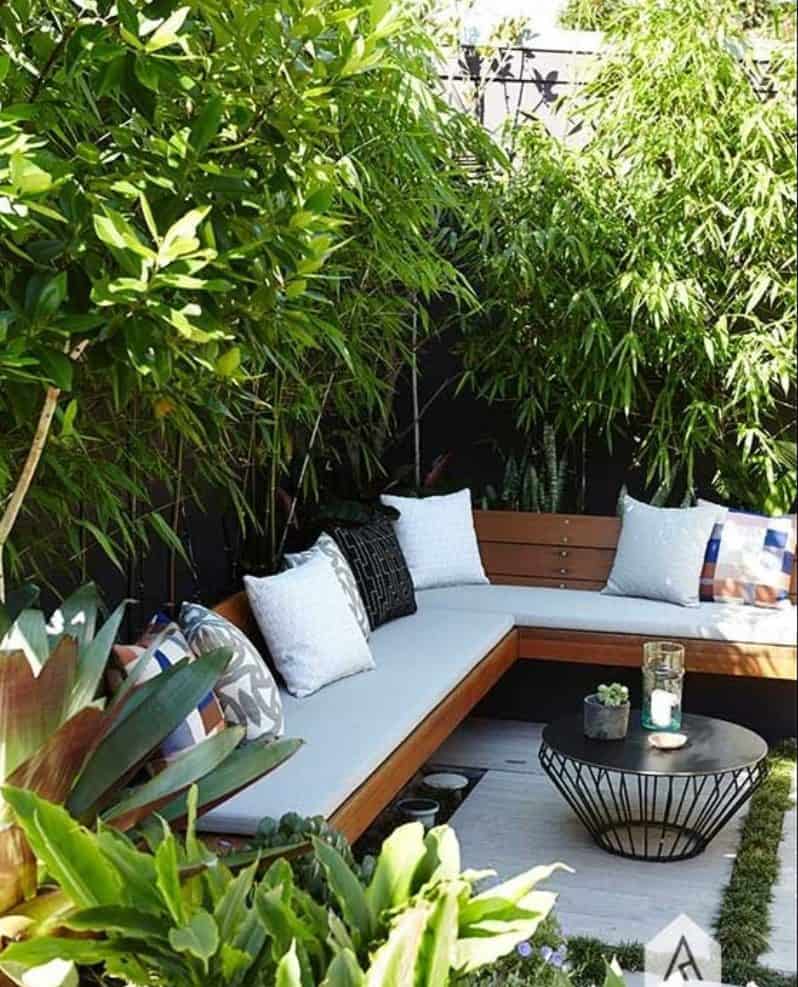 A mini outdoor space with hedges for privacy