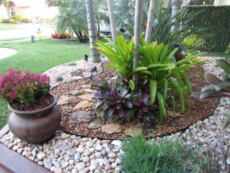 Stones and mortar, creating a garden bed filled with tropical plants