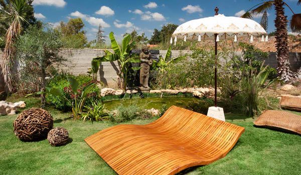 A luxury tropical garden setup with massive sun lounger