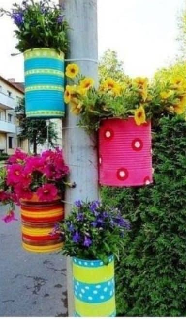 Recycled old cans turned into pretty hanging garden pots