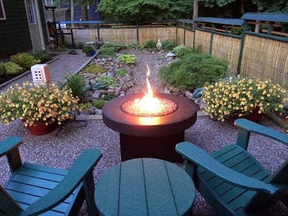 A modern fire pit with a pebble path 