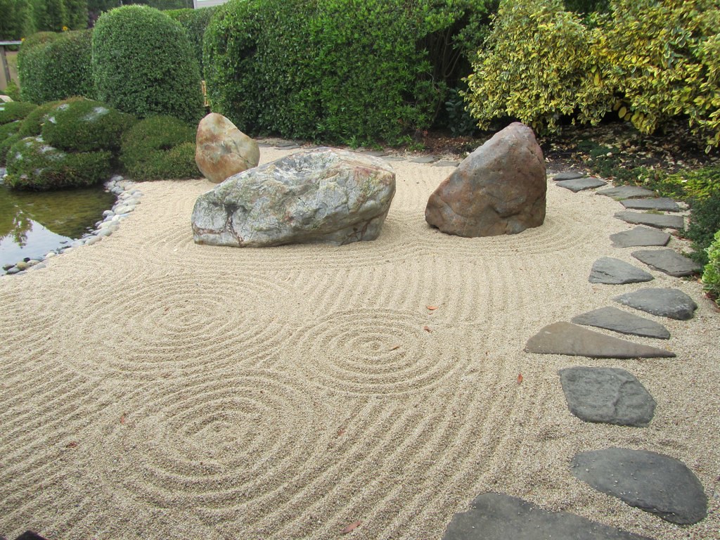 Spiral sand shapes with rock steps and sculptures.