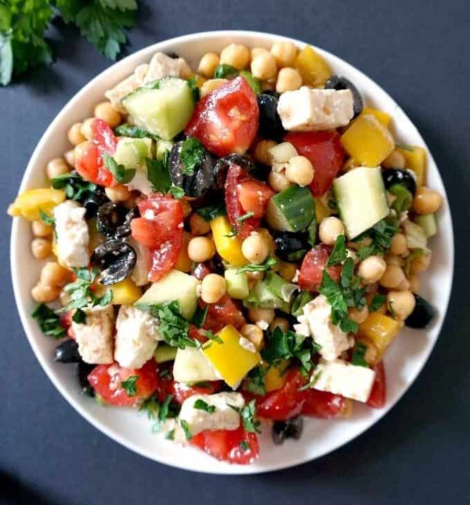 A bowl of Mediterranean chickpea salad with loads of toppings