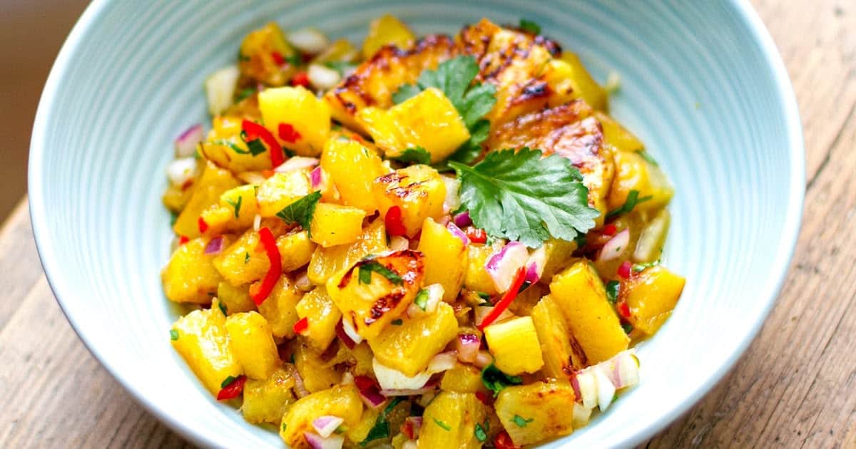Grilled pineapple salsa in a white bowl