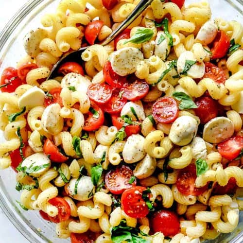 Caprese pasta salad in a large clear bowl