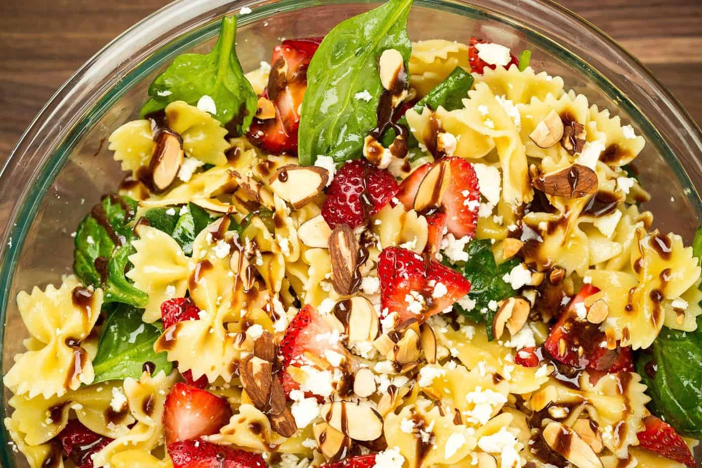 A bowl of strawberry pasta salad with balsamic dressing
