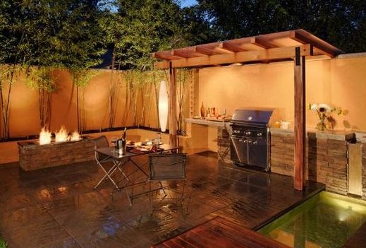 A semi pergola BBQ shelter placed in an outdoor seating area with a fire pit