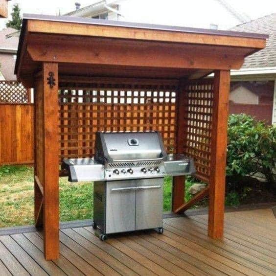 A classic-style wooden gazebo used as a BBQ shelter