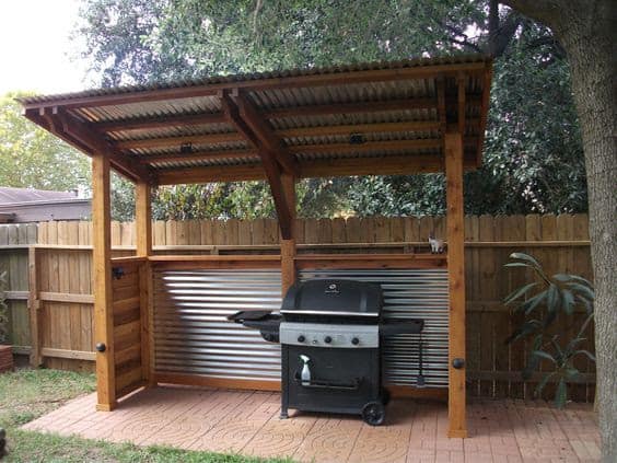 DIY BBQ shelter made from wooden and metal roof materials
