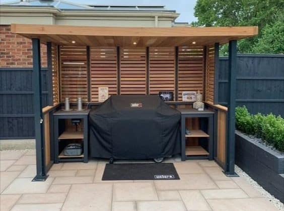 A garden BBQ area made of cedar wood with black finish metal frames