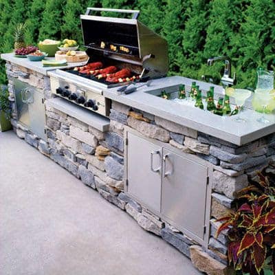  Stone outdoor kitchen with a sink and storage cabinets