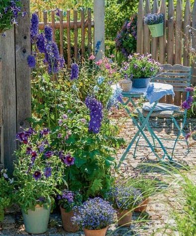 Cottage garden with flowers and furniture in blue tones