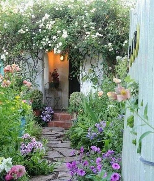 Small path and flowers at the side of a cottage garden