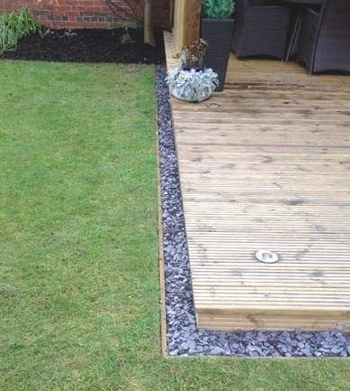 A small pebble border to a garden decking