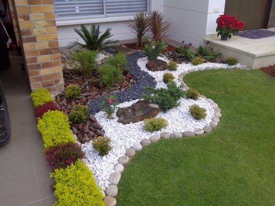 Large pebbles used as a border between the bed and grass