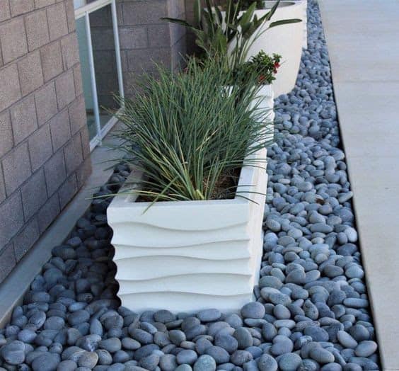 Planters on top of beach pebble base