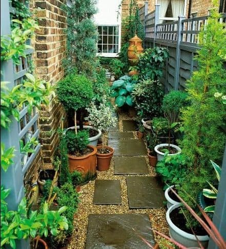 Side yard pebbles and stepping stones as a garden base