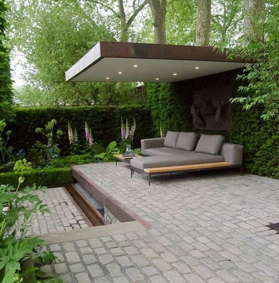 Bespoke garden resting spot with a solid roof to provide some shade 